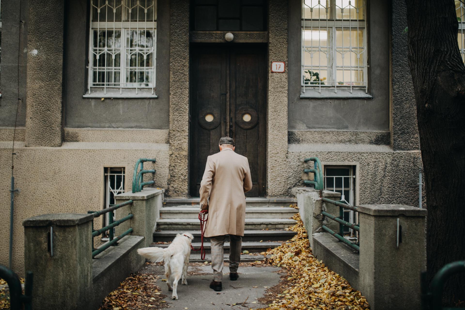 rear-view-of-elegant-senior-man-coming-home-from-w-2022-01-28-01-16-05-utc